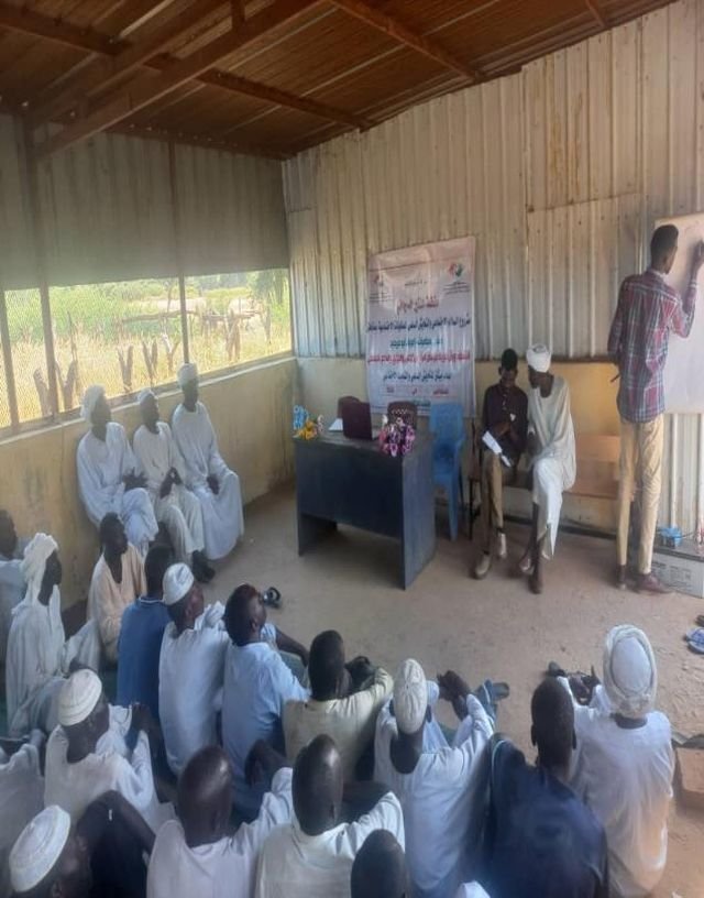 A session in progress inside a community hall