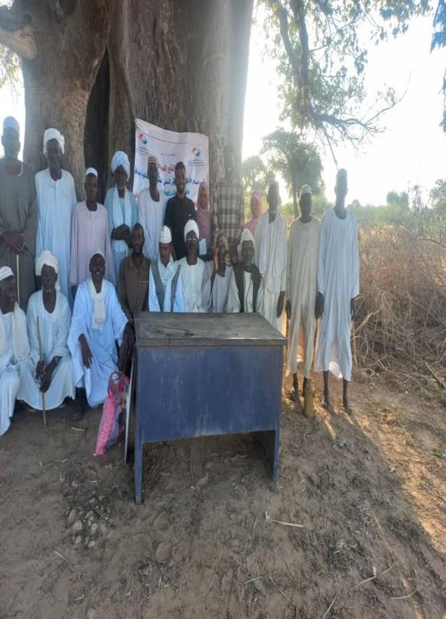 Community members at an outdoor meeting point