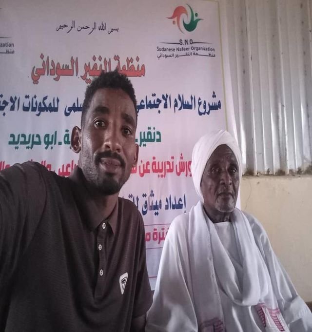 Volunteers with a community member during an activity